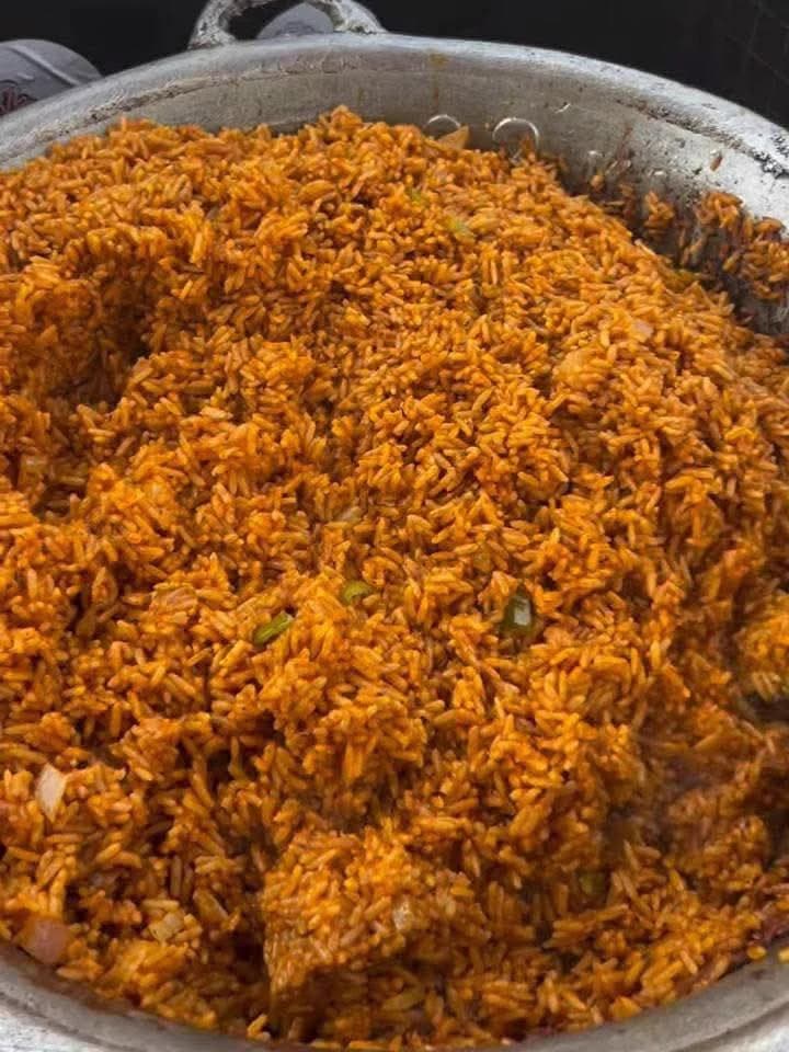 A large catering pot filled with jollof rice cooked for a bulk order