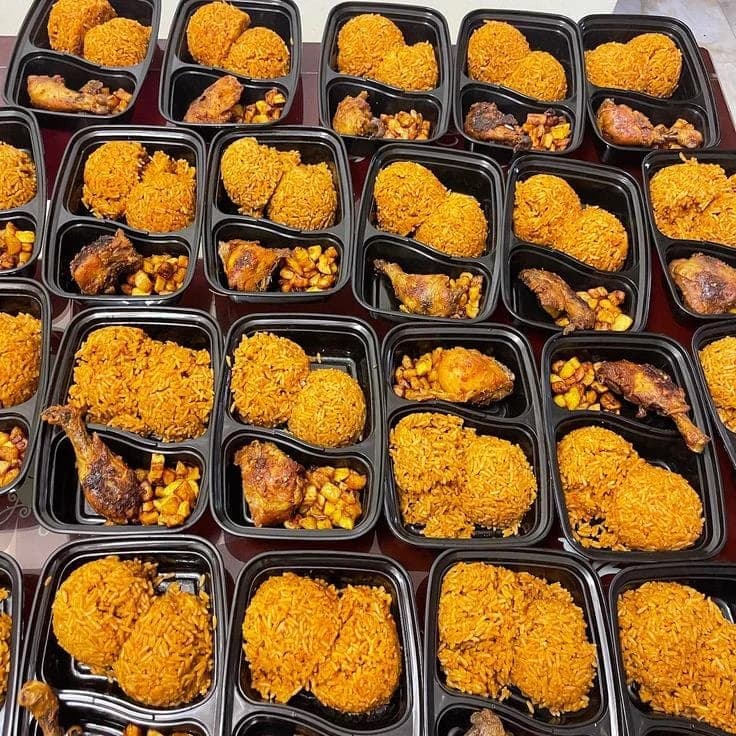 A portion of rice served with fried plantain in a Dlawz lunch pack