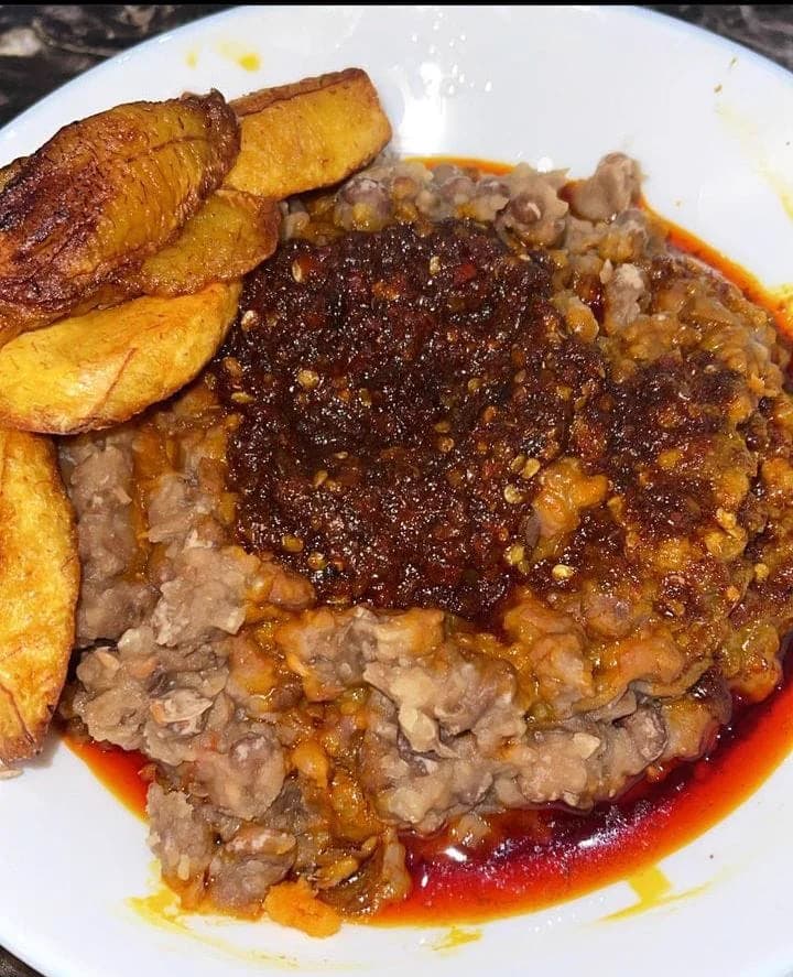 A plate of Dlawz beans and fried plantain served with a rich pepper stew